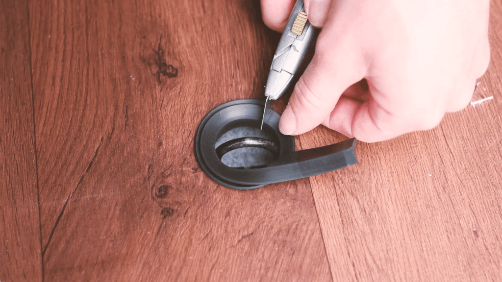 Cutting the rubber L-section to fit