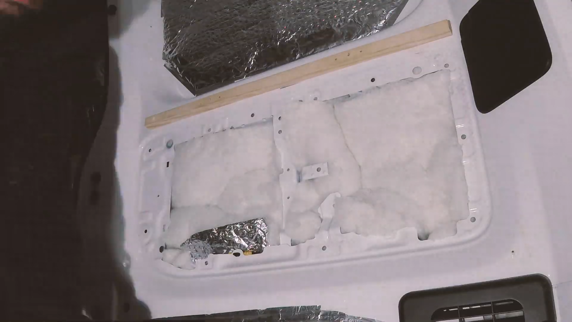 Van wall cavity filled with recycled plastic loft insulation