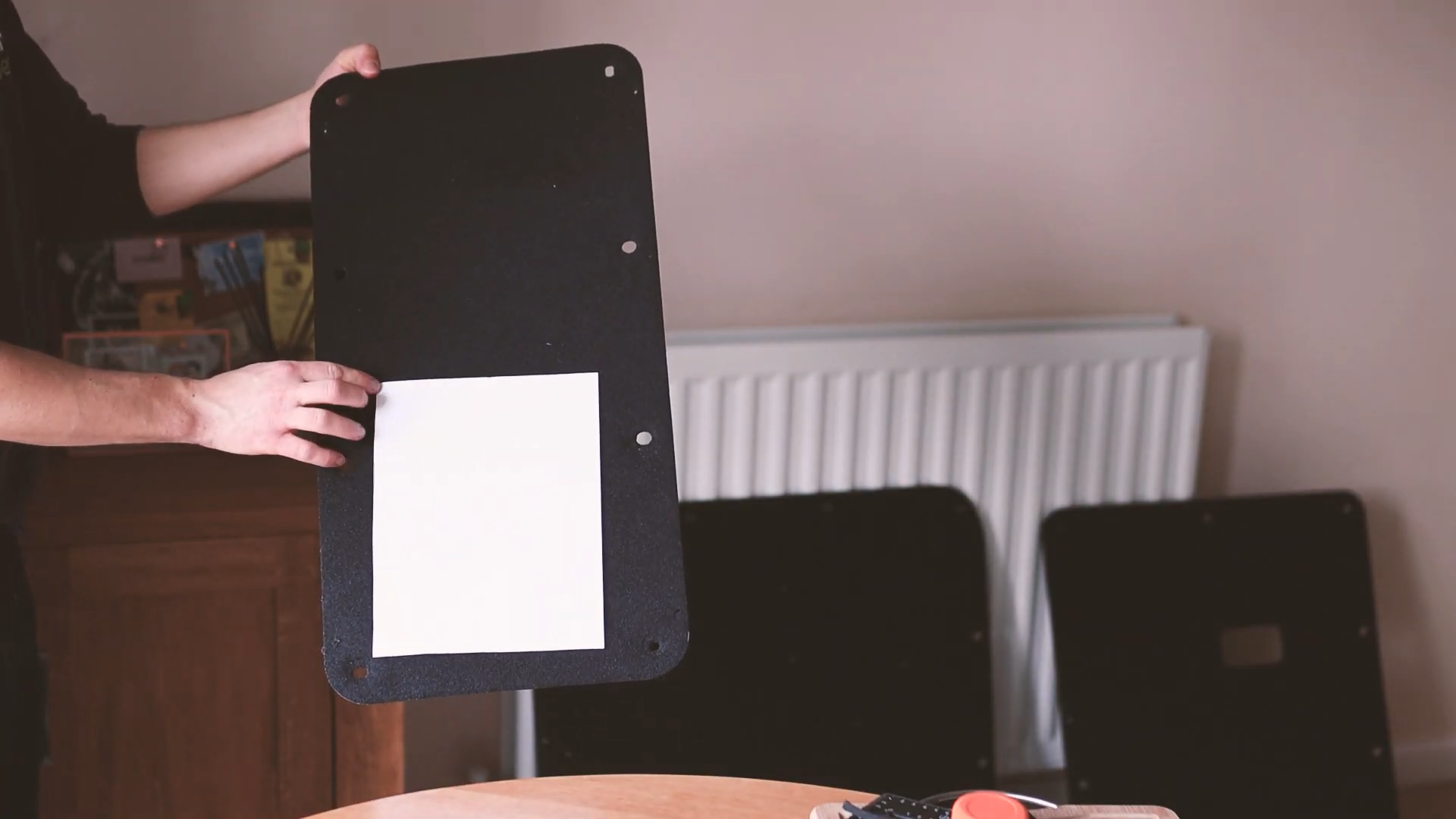 A rectangle paper template held up against the van door card
