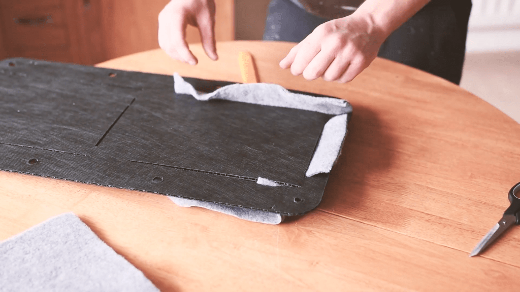 Pulling the carpet pocket through the back of the door card