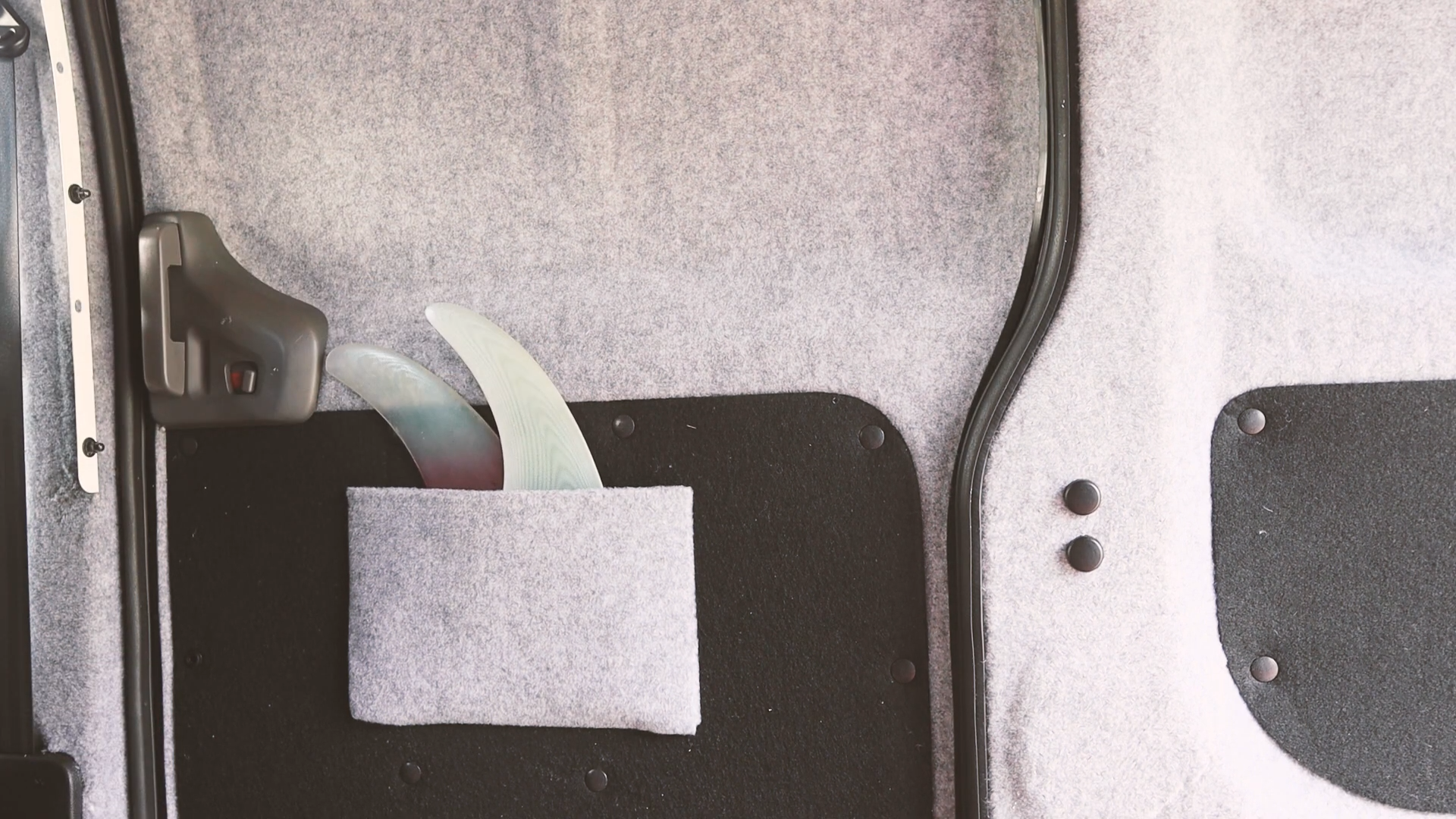 Side door pocket holding two surfboard fins