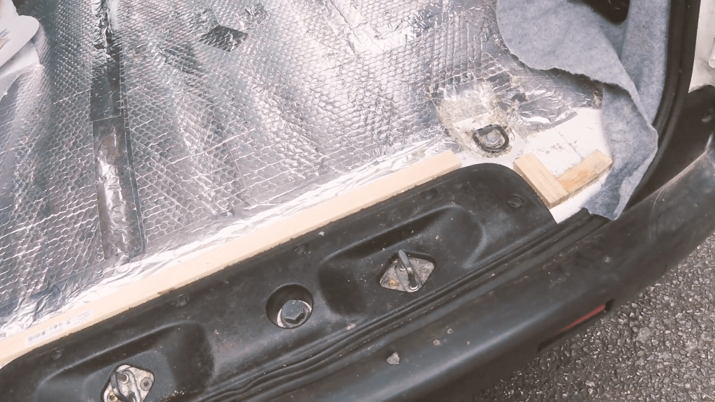 One side of the back door edge of the van floor insulation