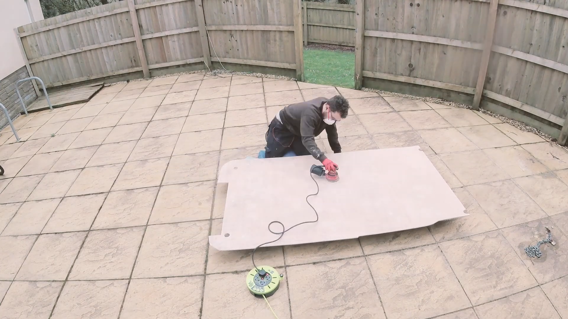 Sanding the surface of the plywood floor