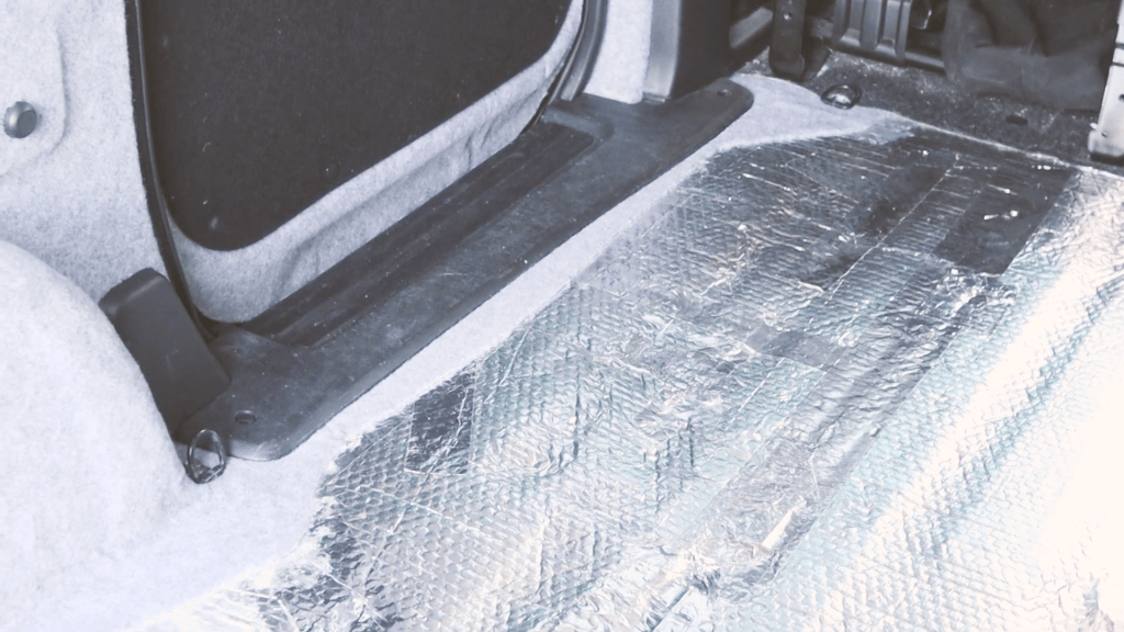 The carpeted edge by the van side doors