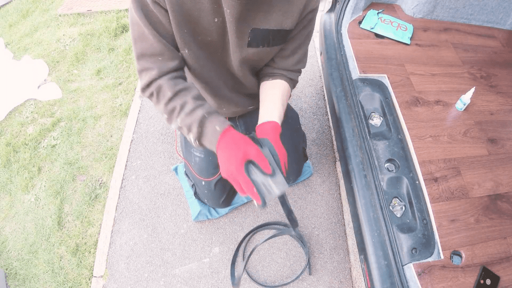 Abrading the rubber L-section with a sanding block