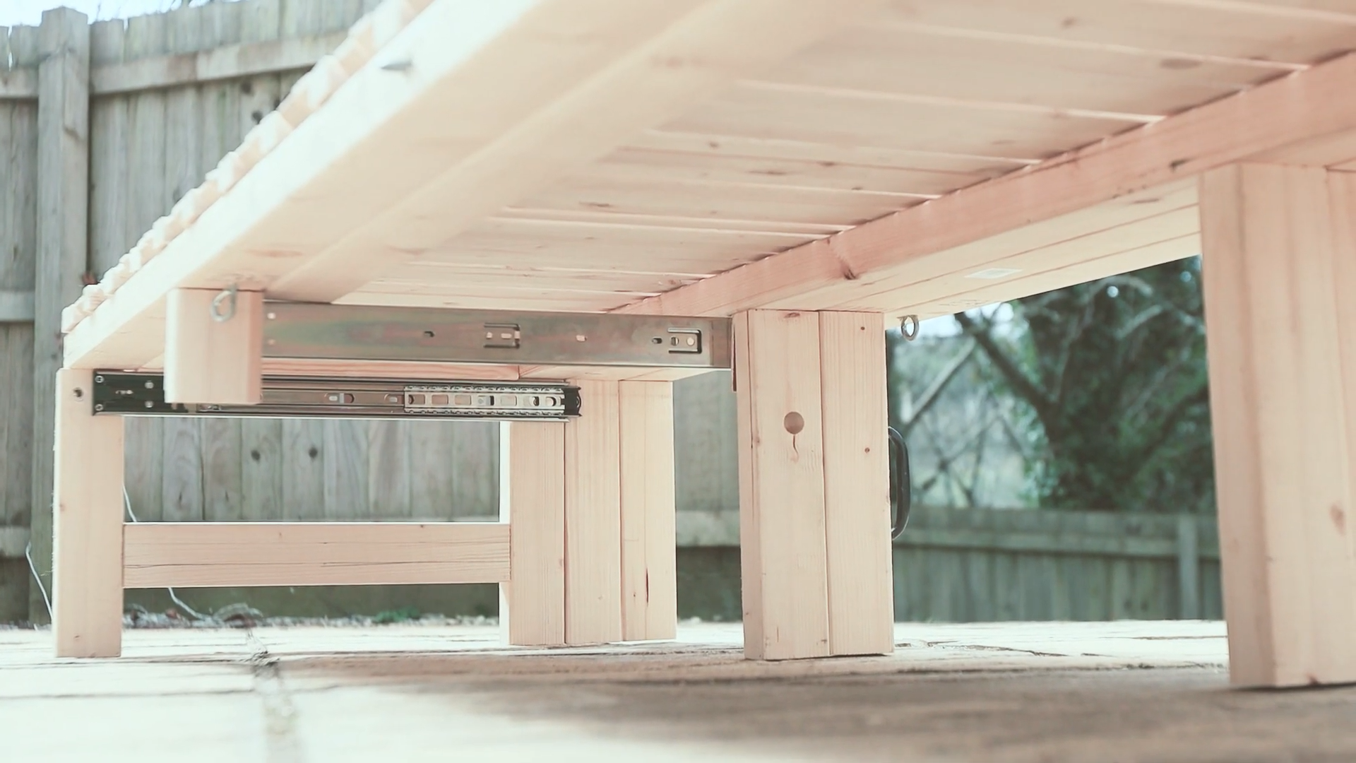 The view under the van bed, showing the frame and drawer sliders