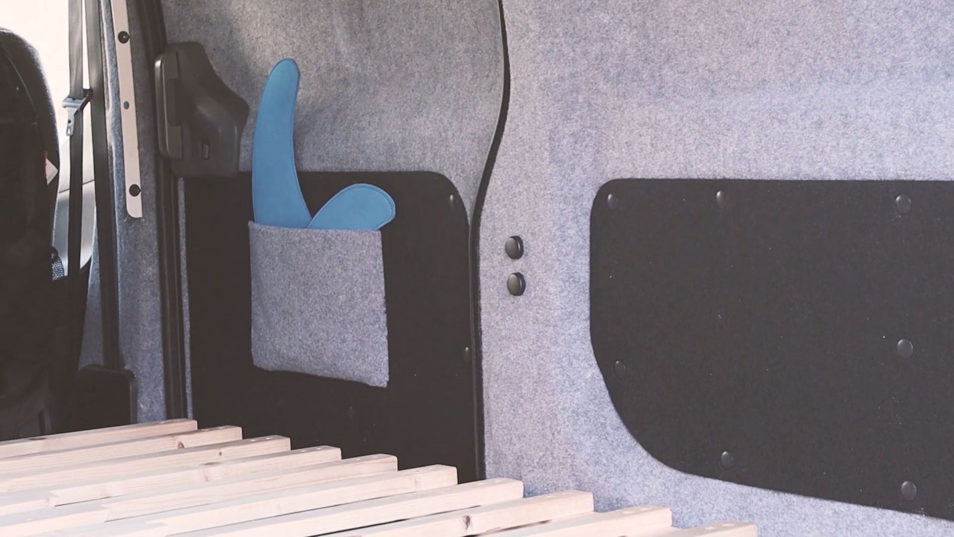 Image showing van door pockets sitting above the pulled out van bed