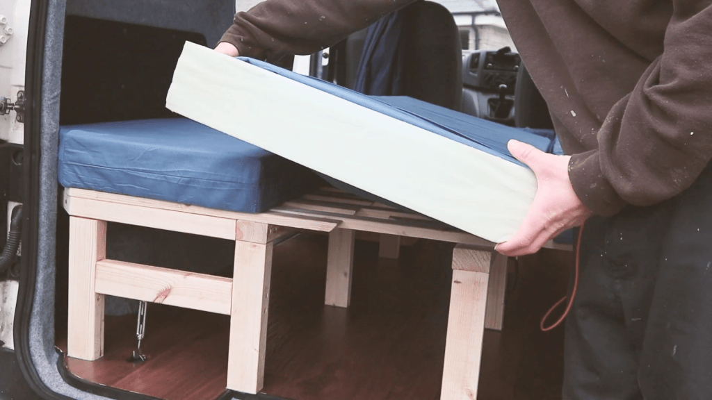 A mattress with the cover pulled back, showing four inch thick foam inside
