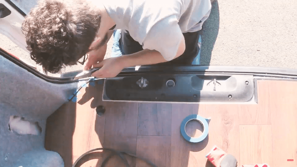Gluing black rubber L-section to the van floor edge
