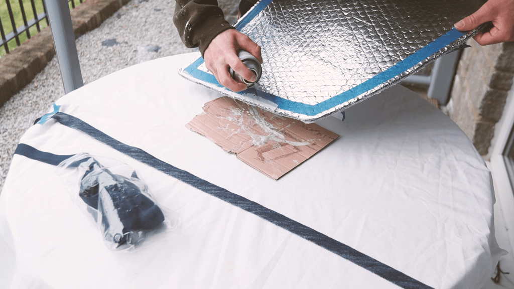 Spraying contact adhesive on the window cover edges