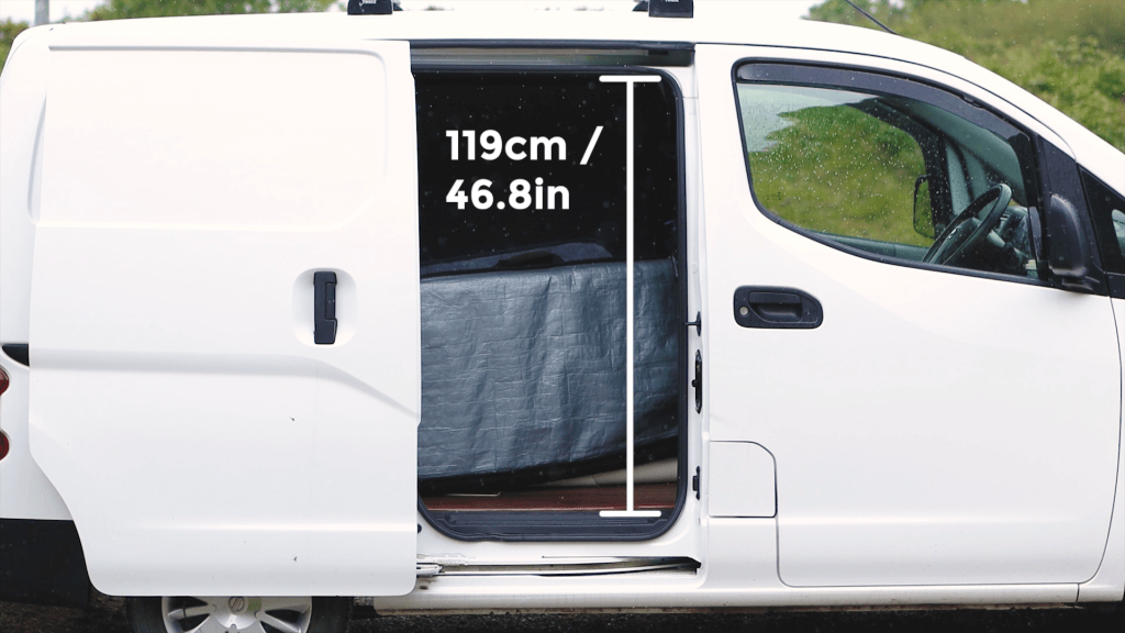An open Nissan NV200 sliding side door with height measurements