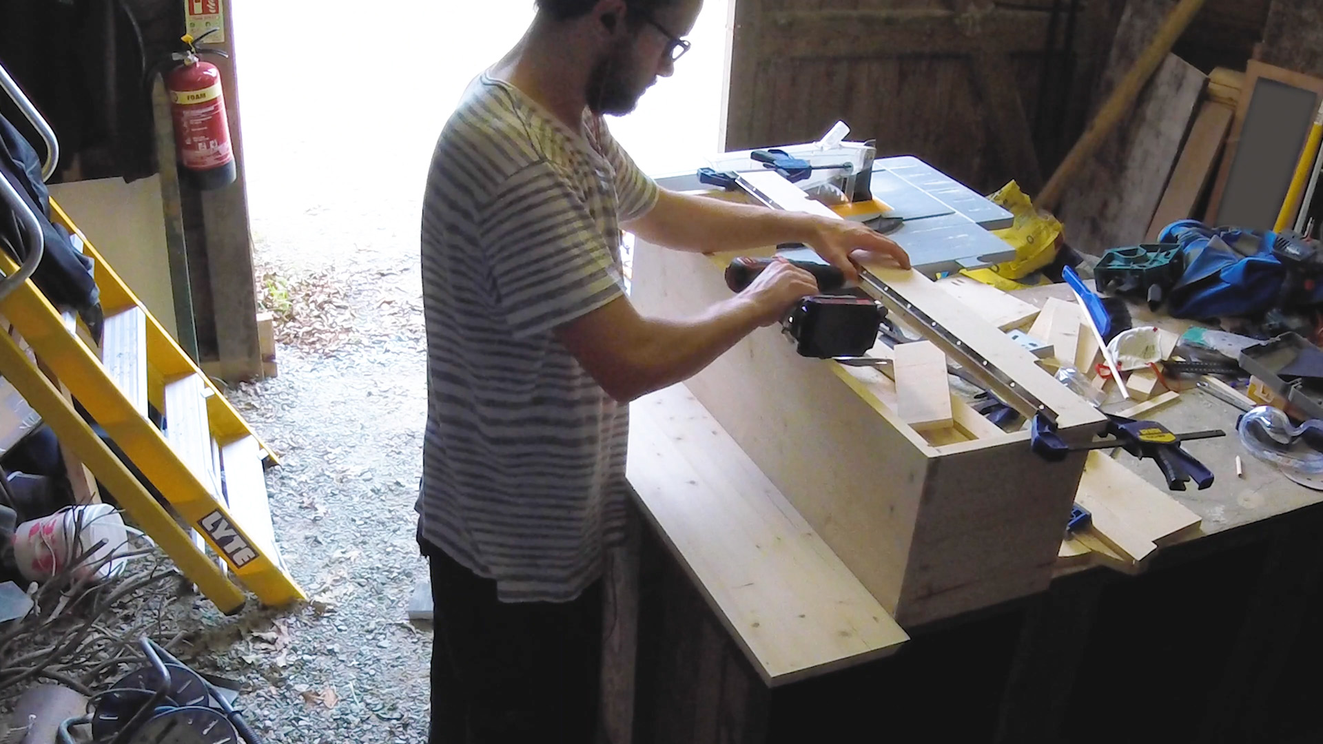 Screwing the continuous piano hinge onto the lid of the box