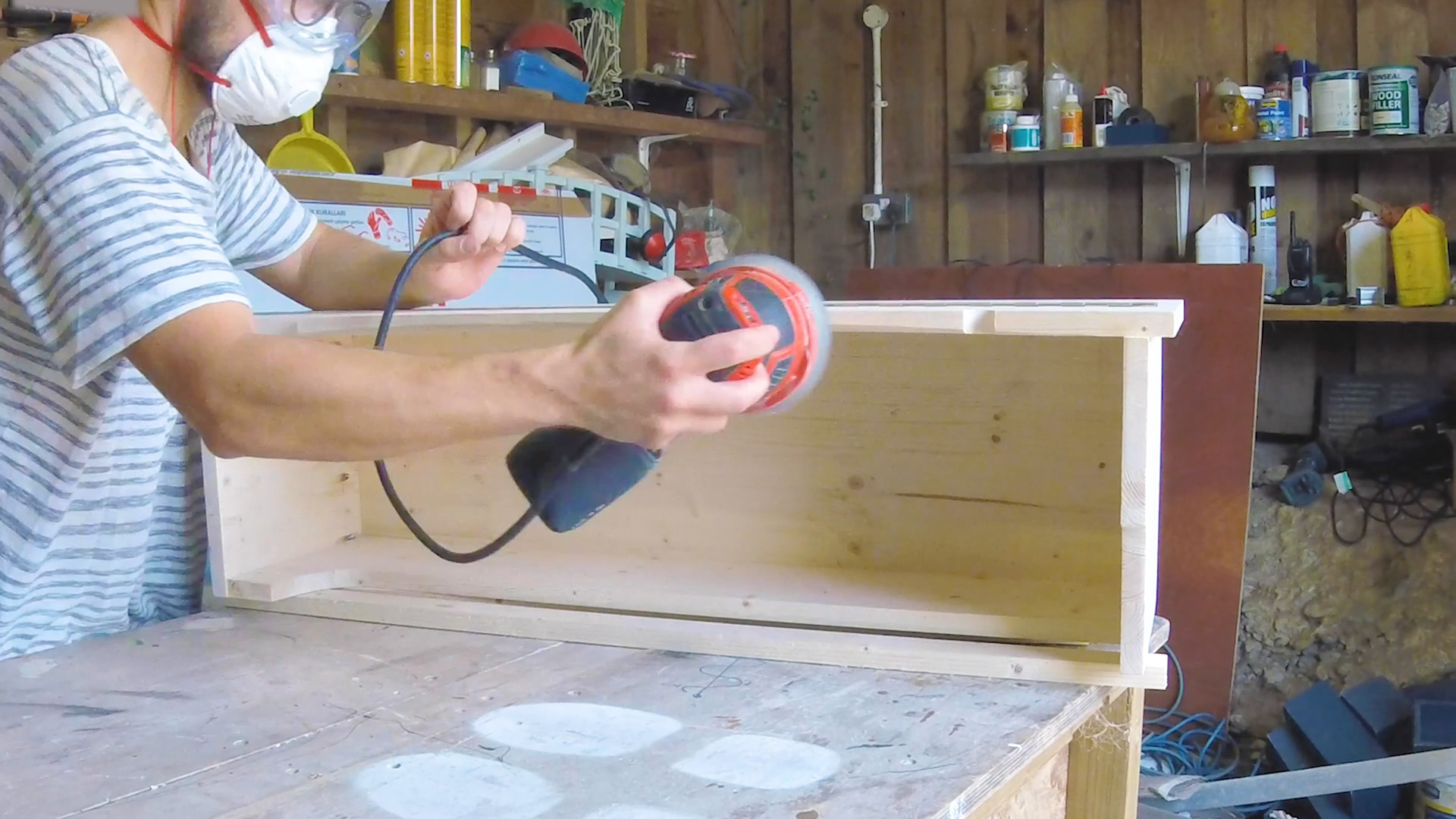 Sanding the wooden wheel arch storage box