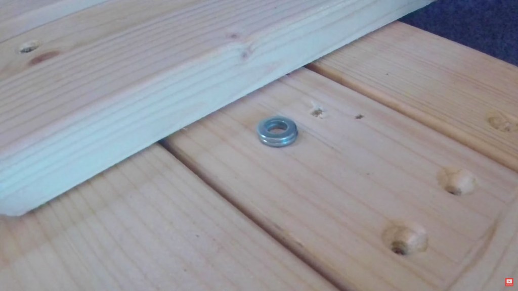 Washers under the bed slat to raise it and make pulling out the bed smoother