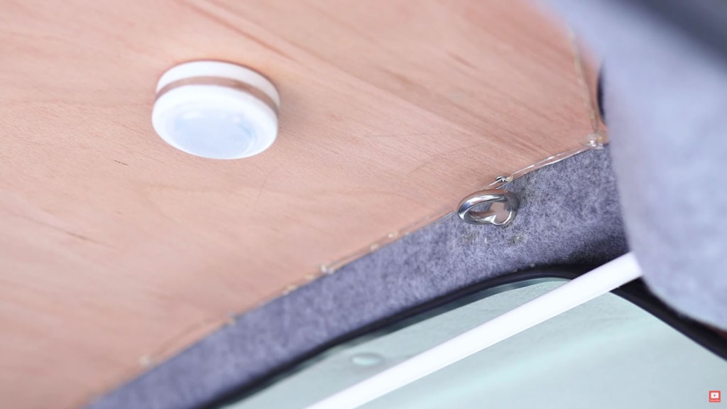 An eye ring screwed into empty M8 screw thread near the van ceiling