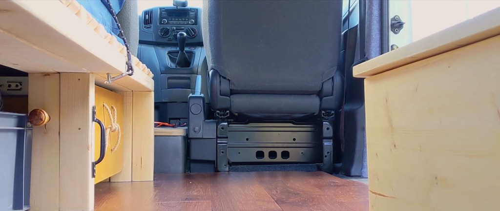 The empty space behind the drivers seat in the van