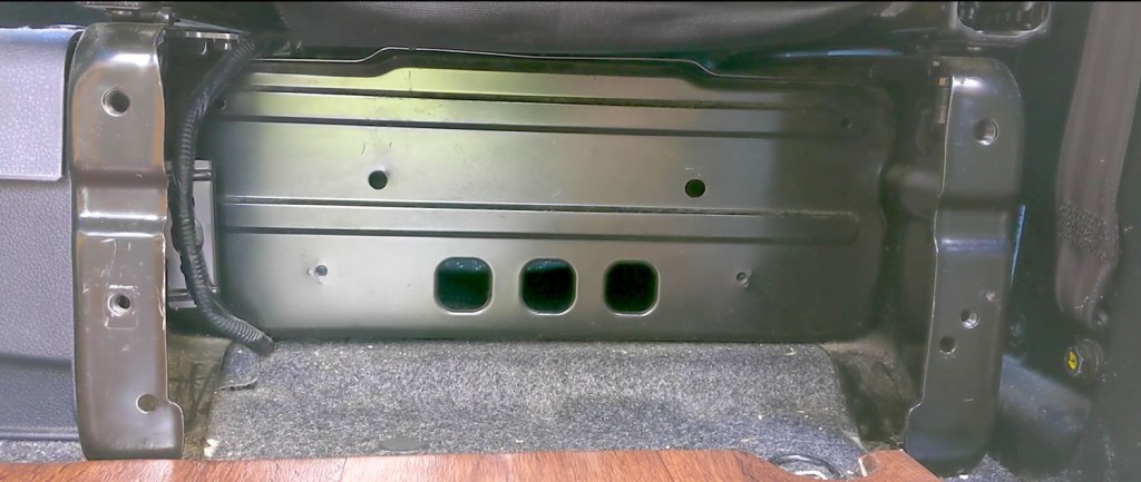 The empty space behind the drivers seat in the van