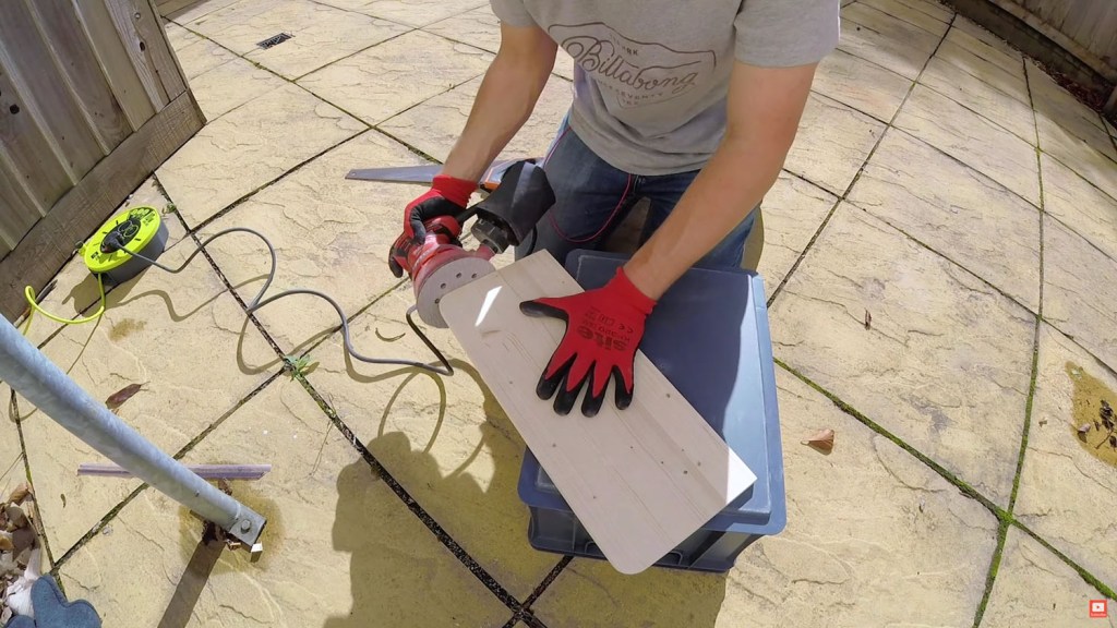 Sanding the edges of the wood board
