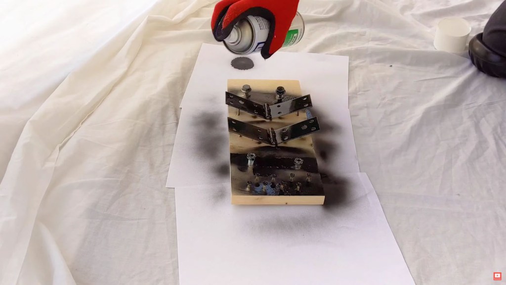 Spray painting the hinges, nuts, bolts and screws matt black