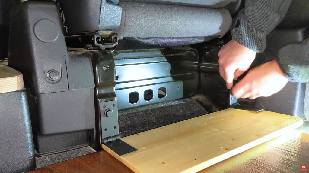 Fixing the hinges to the drivers seat and marking screw holes for the door