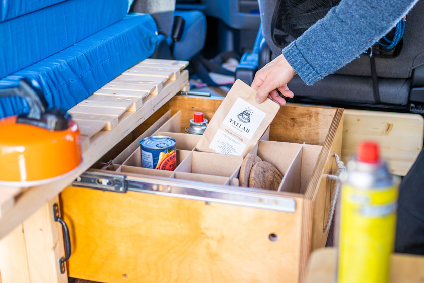 Loading up the under bed draw with van essentials