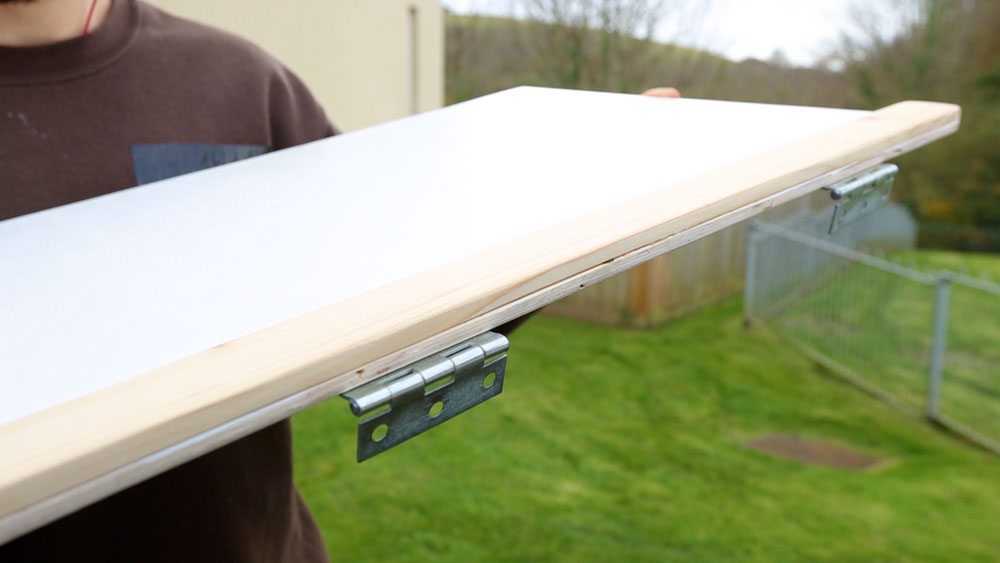 A strip of wood used to thicken where the hinges attach to the plywood