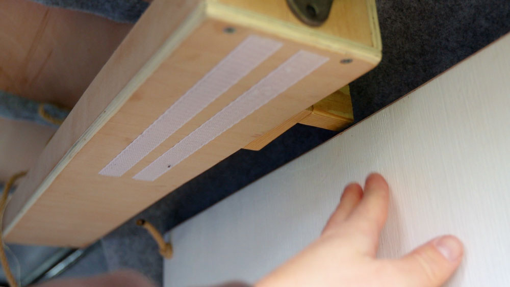 A latch for the table hidden behind the shelf