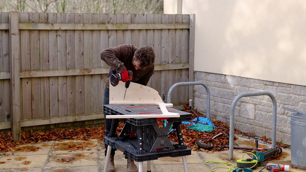 Screwing the table side pieces onto the front piece