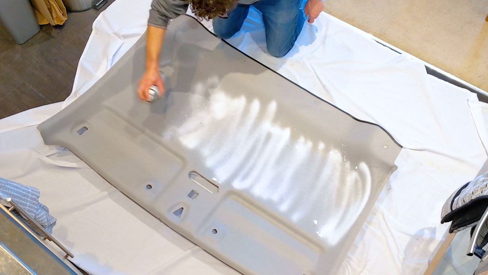 Spraying the headliner with an upholstery cleaner