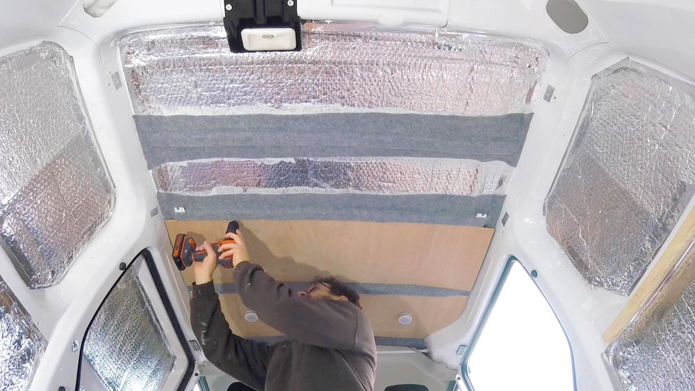 Screwing plywood panels over the foil insulation on my van ceiling