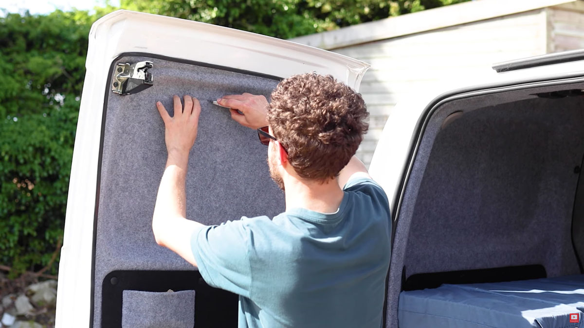 Cutting through the van door carpet