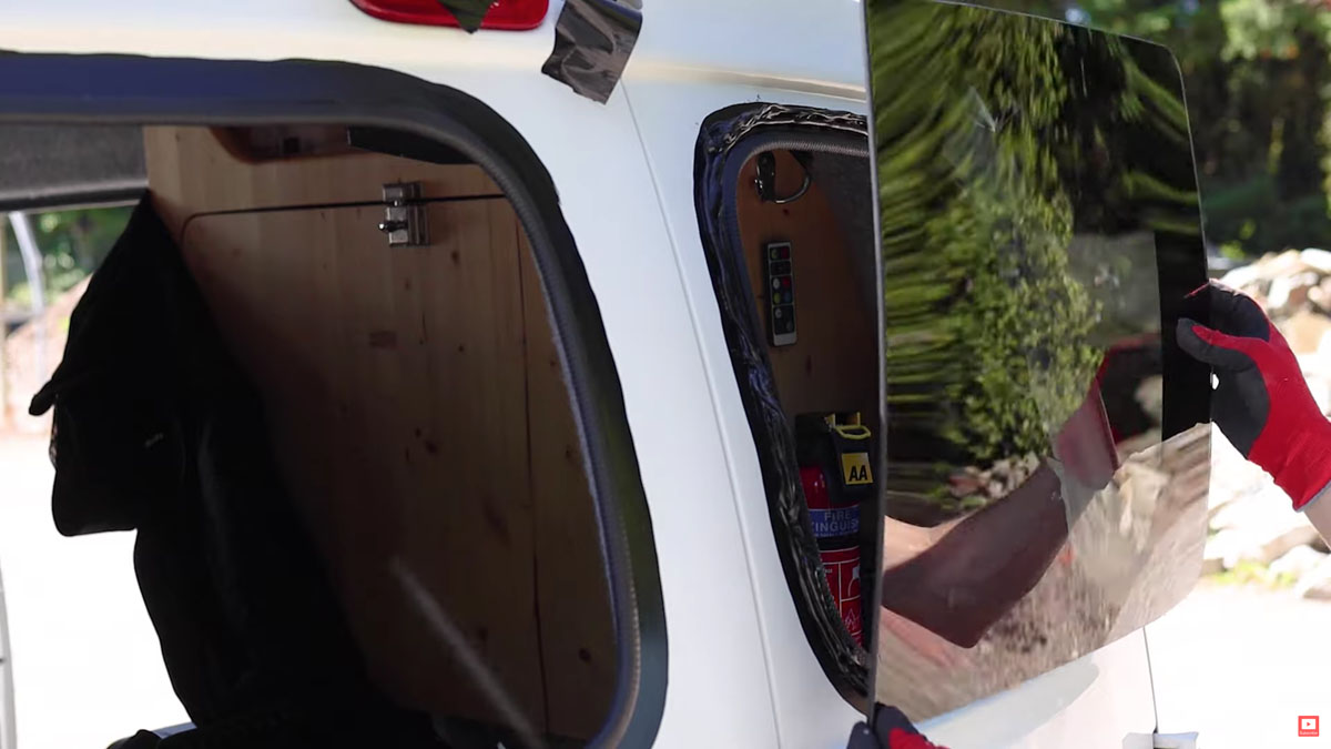 Sticking the first van window in place