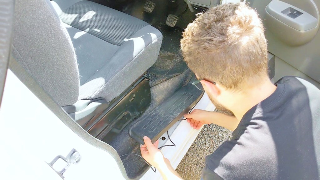 Routing the rear view window camera cables under the door trim of the van
