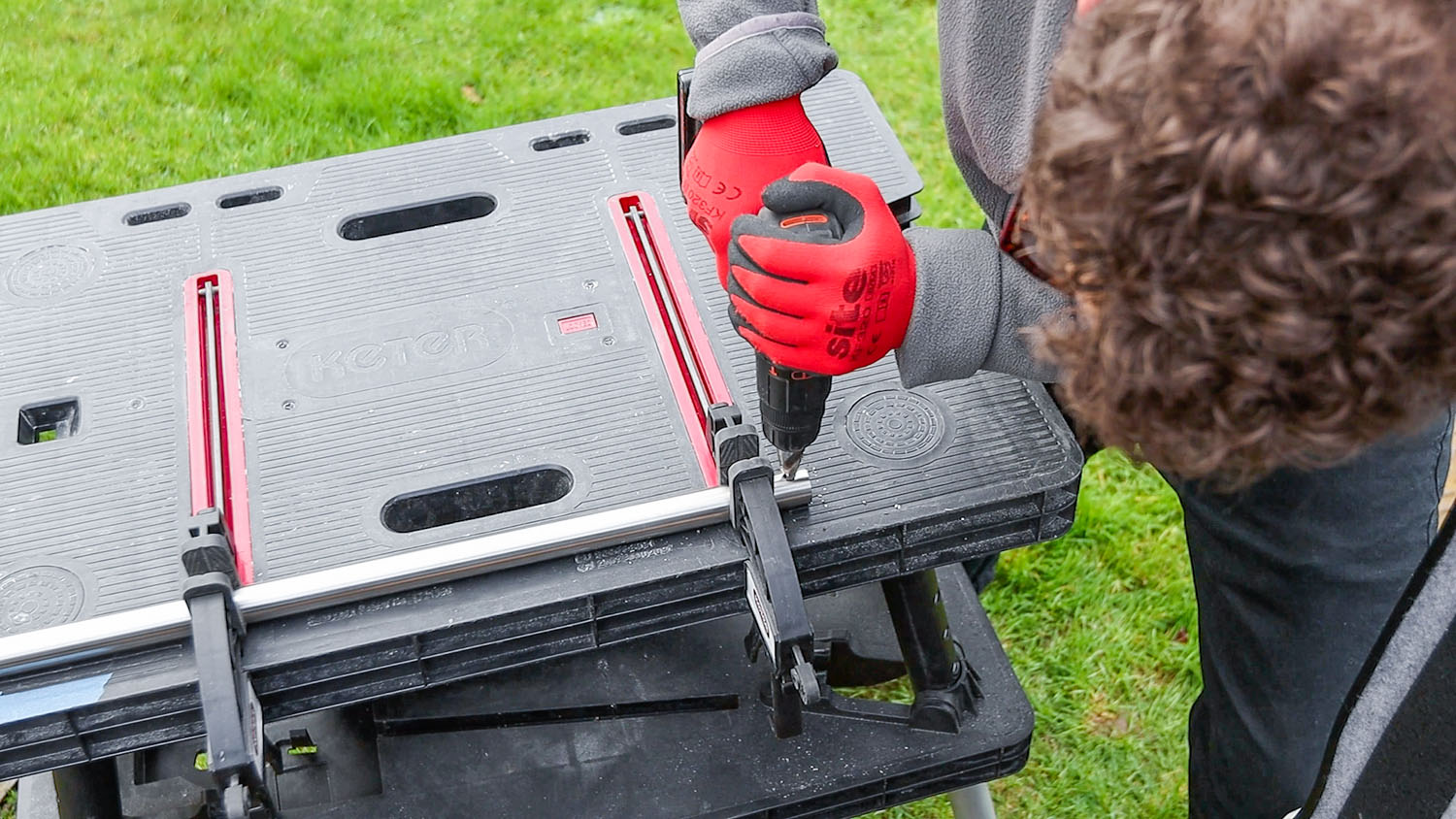 Drilling holes for the grommets in the ends of the metal door bar