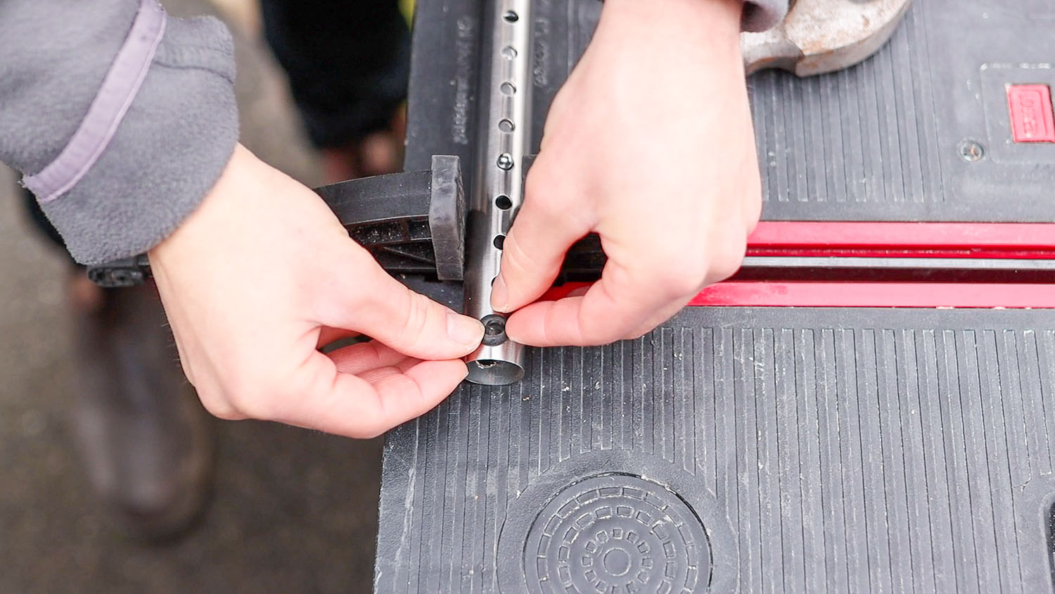 Inserting the rubber grommets into the door bar