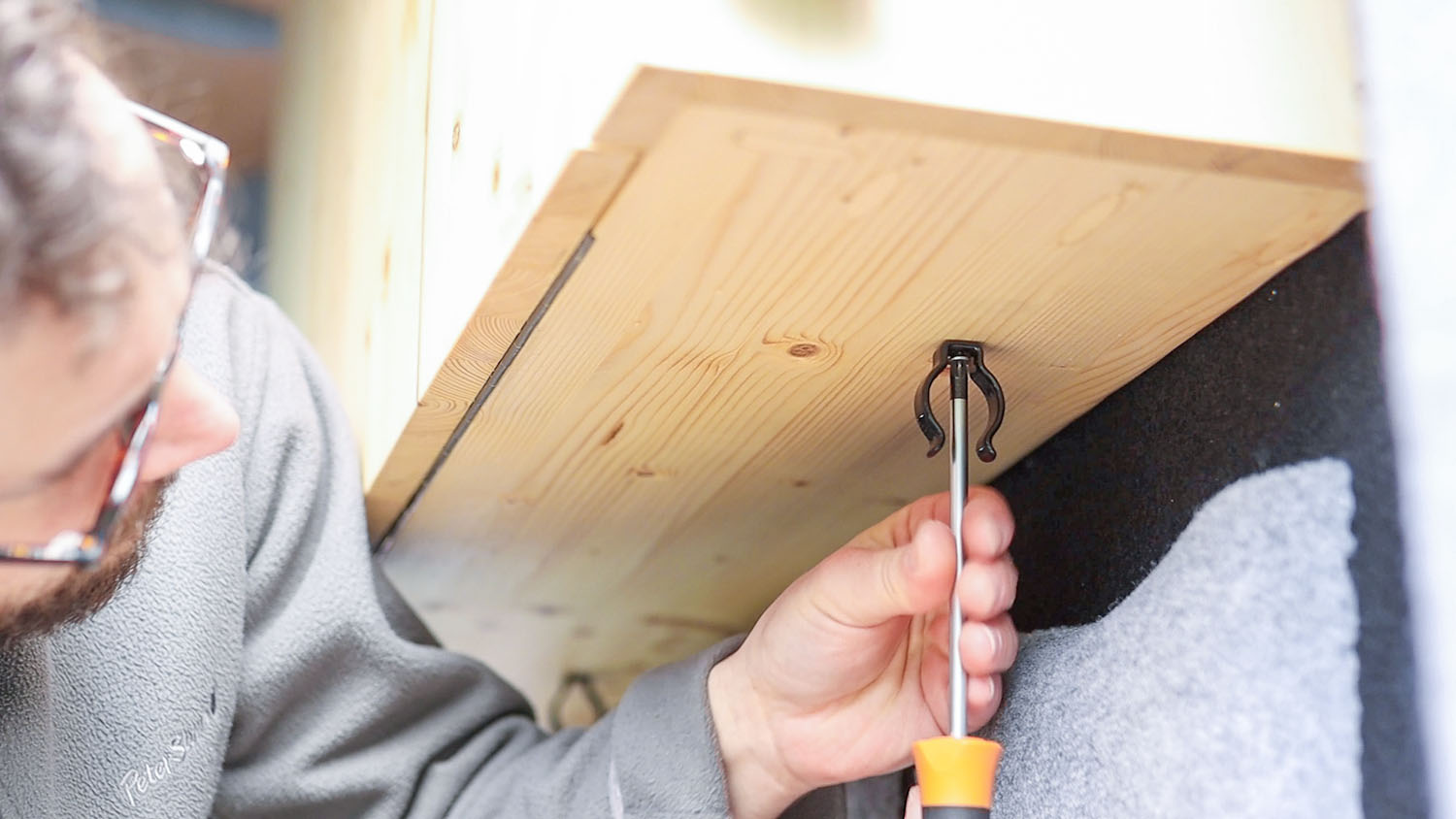 Attaching the terry tool clips to the underside of the floating wall table unit