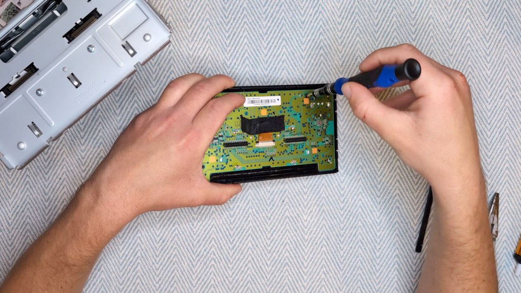 Adding the screws back to the Nissan Daewoo circuit board