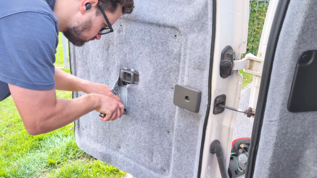 Cutting into the rear door cavity carpeting and insulation