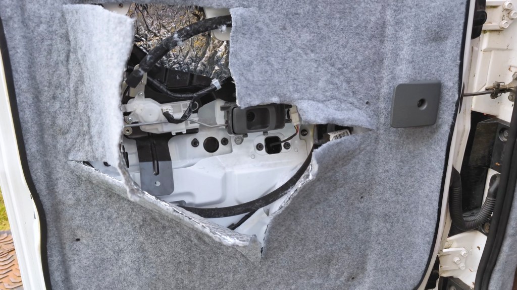 Inside the rear door cavity of a Nissan NV200