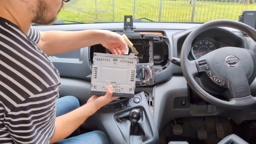 Popping up the vent knob on the Nissan dashboard