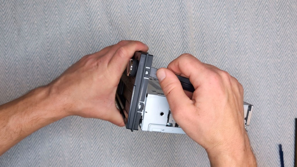 Prying off the front of a Nissan Daewoo head unit