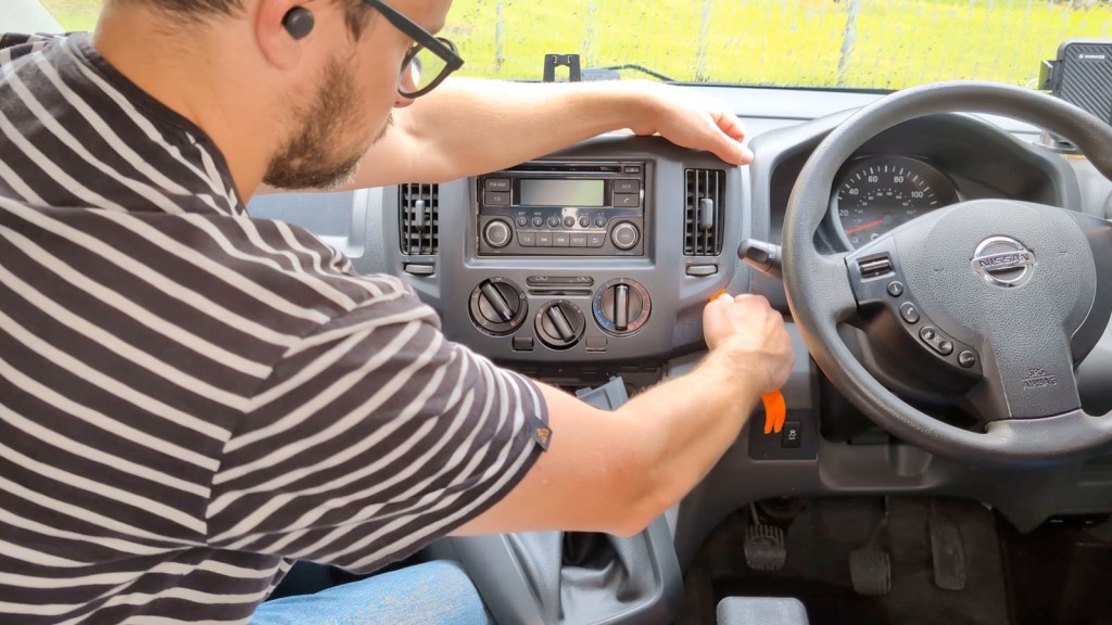 Prying up the lower trim on a Nissan Nv200 2