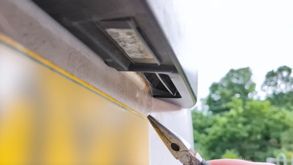 Pulling fishing line through the rear door handle to route the reversing camera cable