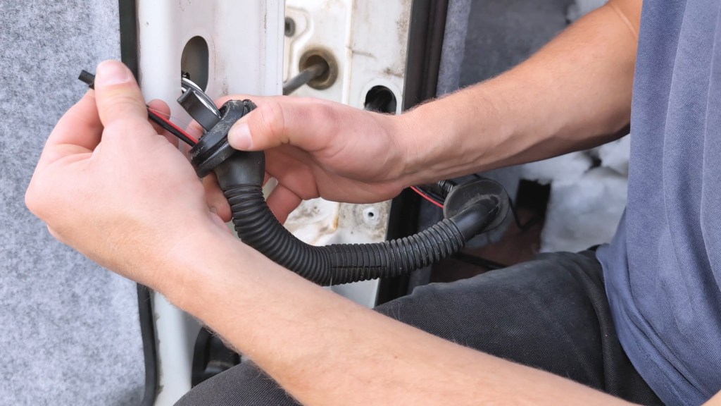Pulling the rearview camera cable through the rear door hose