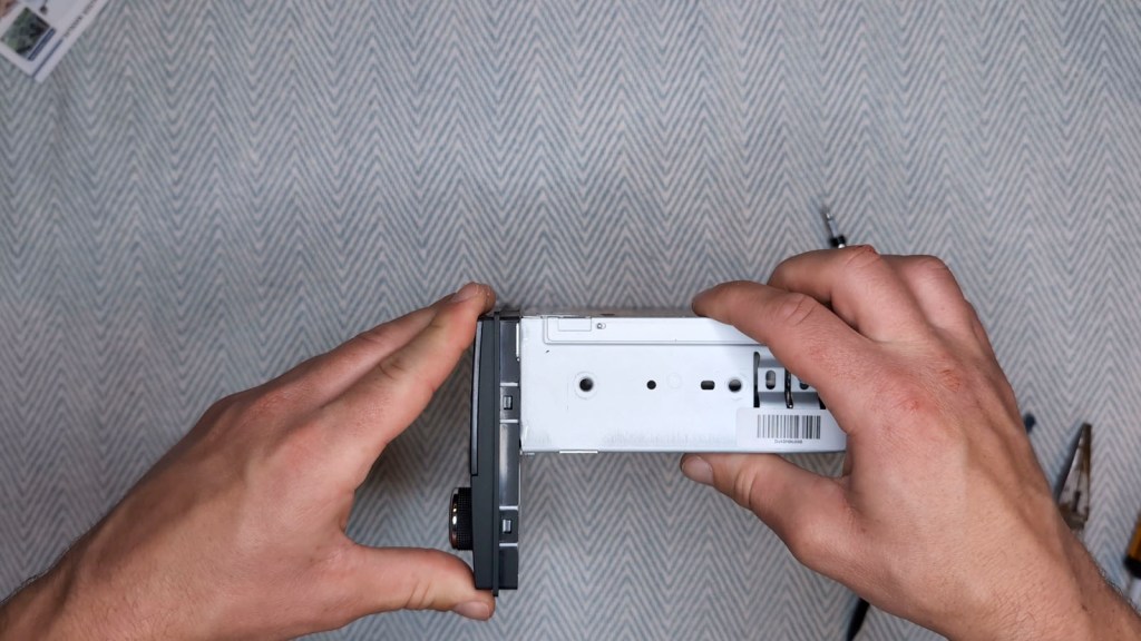 Pushing the front back on to the Nissan Daewoo head unit