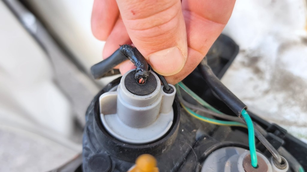 Red reversing light cable showing under tape