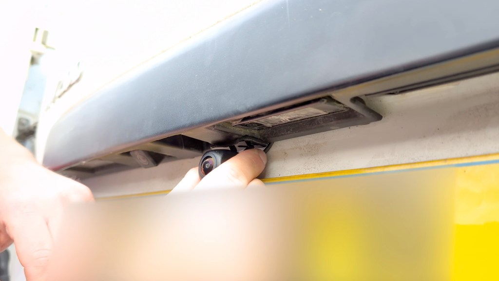 Sticking the reversing camera to the back of the vehicle