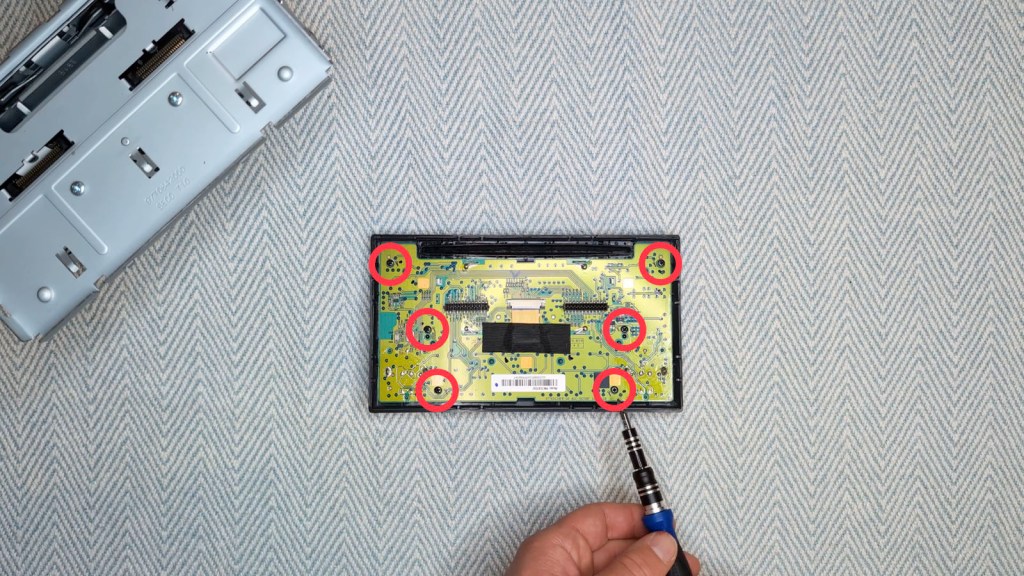 The six screws on the circuit board of a Nissan Daewoo radio stereo head unit