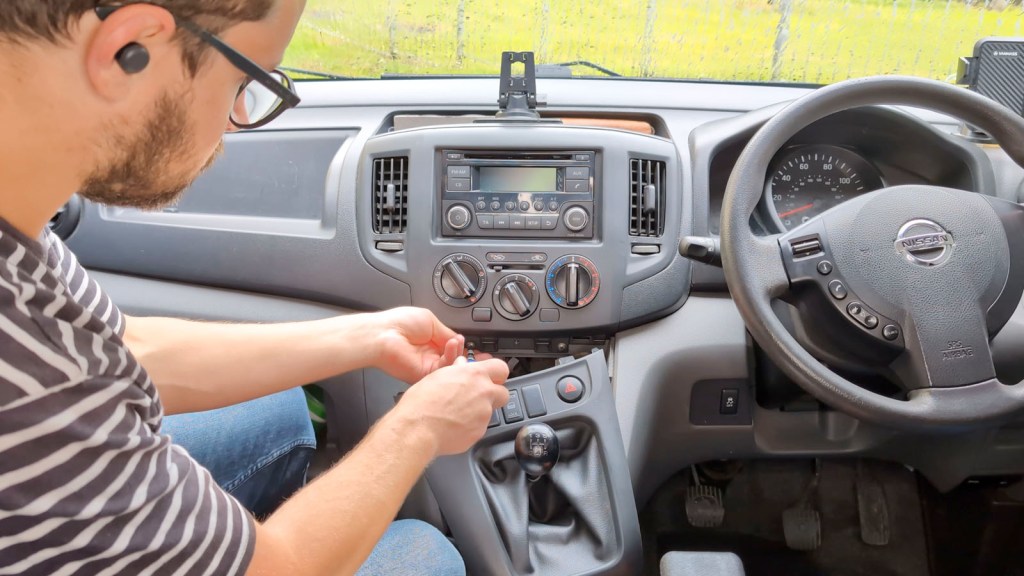 Undoing the lower trim screws on a Nissan dashboard