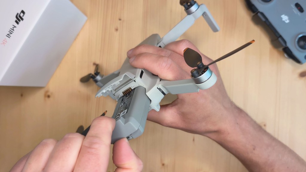 Removing the Intelligent Flight Battery from the The battery compartment of the DJI Mini 4k Camera Drone